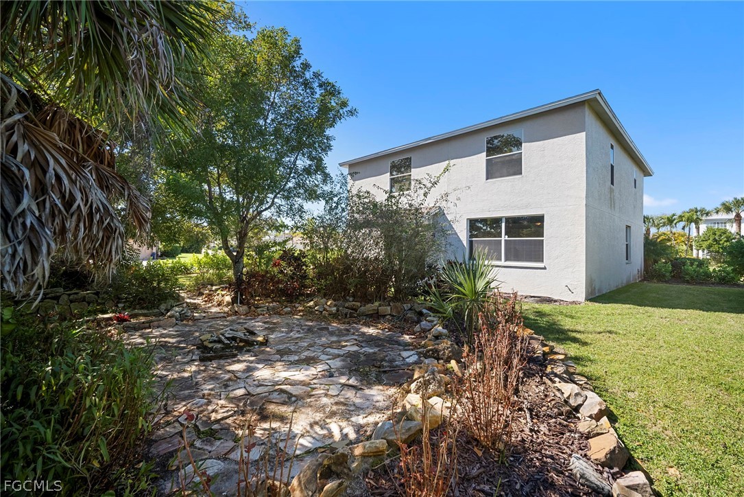 21768 Brixham Run Loop Estero, FL 33928 - Photo 36 of 36 a backyard of a house with a tree