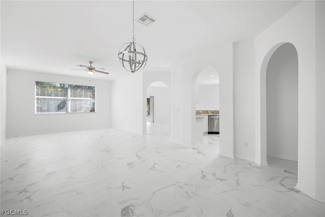 21768 Brixham Run Loop Estero, FL 33928 - Photo 5 of 36 a view of a room with a chandelier fan and windows