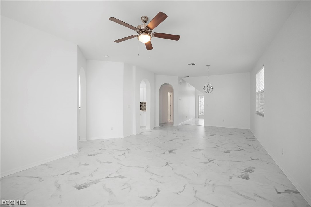 21768 Brixham Run Loop Estero, FL 33928 - Photo 7 of 36 an empty room with chandelier fan and windows