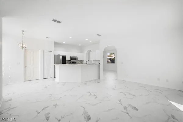 a view of a kitchen with a sink and a refrigerator