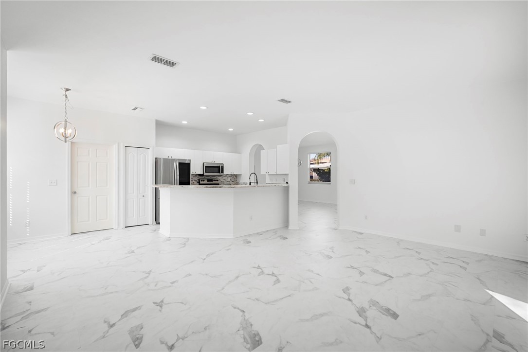 21768 Brixham Run Loop Estero, FL 33928 - Photo 8 of 36 a view of a kitchen with a sink and a refrigerator