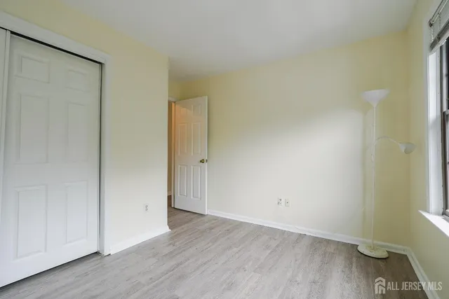 a view of an empty room and wooden floor