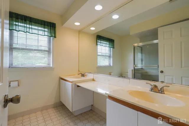 a bathroom with a sink double vanity and a mirror