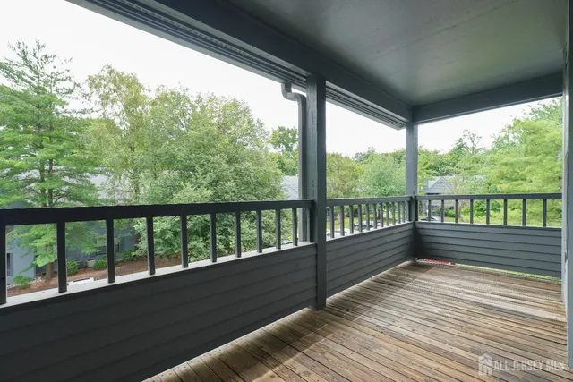 a view of balcony with wooden floor