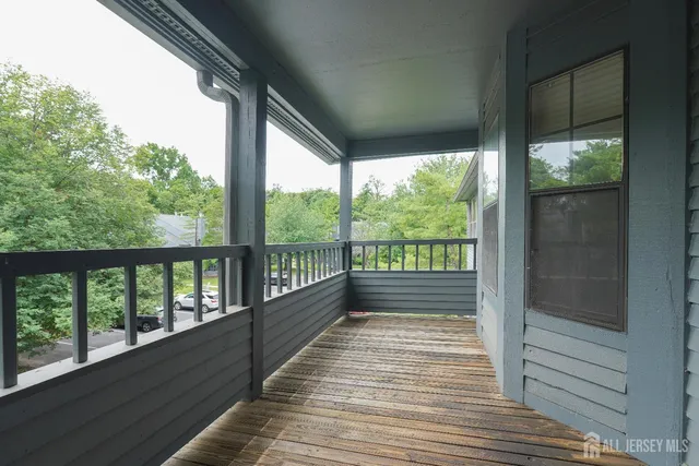a view of a balcony with wooden floor