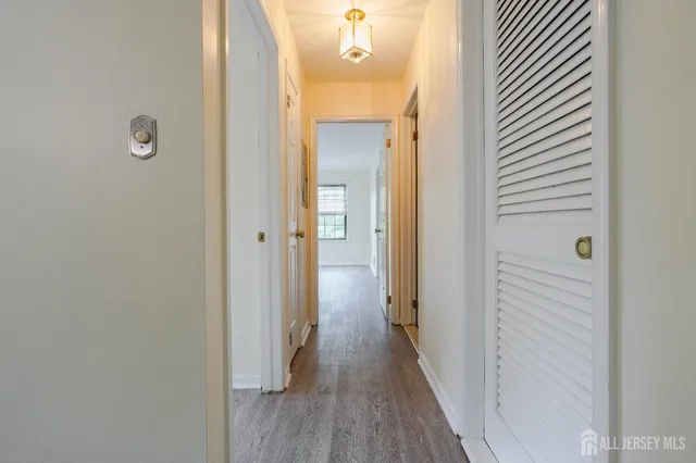 a view of a hallway with wooden floor