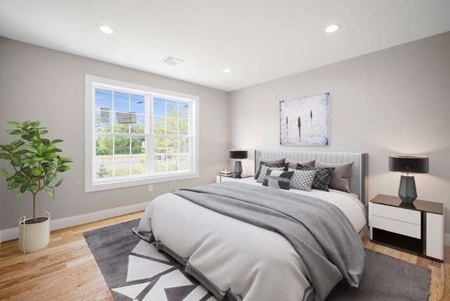 4 Sabrina Way, Unit E Feeding Hills, MA 01030 - Photo 12 of 16 a spacious bedroom with a large bed and a potted plant