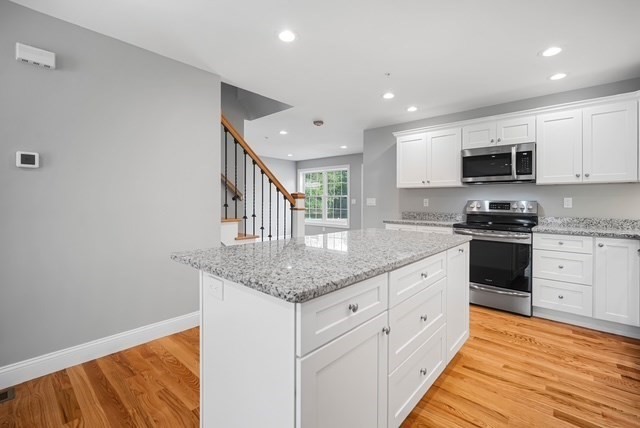 4 Sabrina Way, Unit E Feeding Hills, MA 01030 - Photo 4 of 16 a kitchen with granite countertop a sink and cabinets