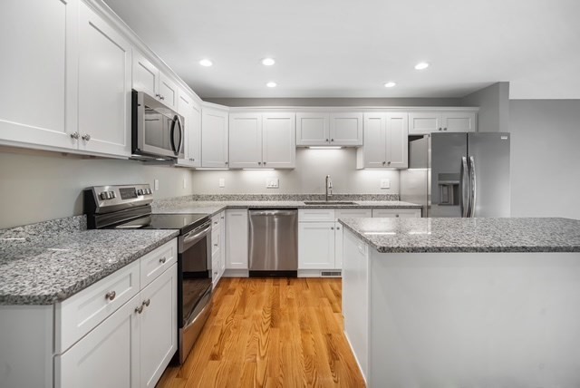 4 Sabrina Way, Unit E Feeding Hills, MA 01030 - Photo 6 of 16 a kitchen with stainless steel appliances granite countertop a sink and cabinets