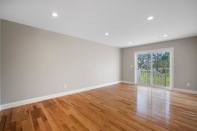 4 Sabrina Way, Unit E Feeding Hills, MA 01030 - Photo 9 of 16 a view of an empty room with wooden floor and a window