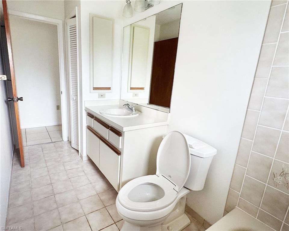699 110th Avenue North, Unit B Naples, FL 34108 - Photo 11 of 23 a spacious bathroom with a toilet sink and mirror