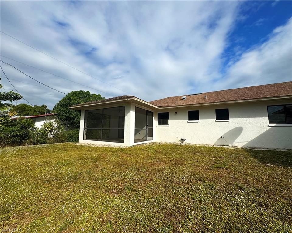 699 110th Avenue North, Unit B Naples, FL 34108 - Photo 3 of 23 a house with yard in front of it