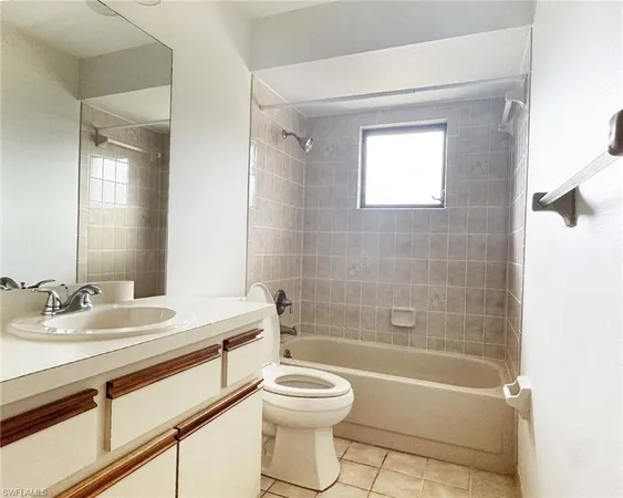 a spacious bathroom with a toilet sink and mirror