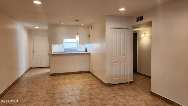a view of a kitchen with a refrigerator and a sink