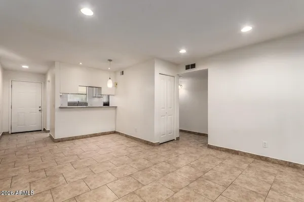 a view of a kitchen with a refrigerator and a sink