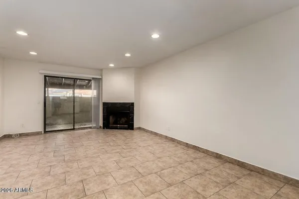 a view of an empty room with a fireplace