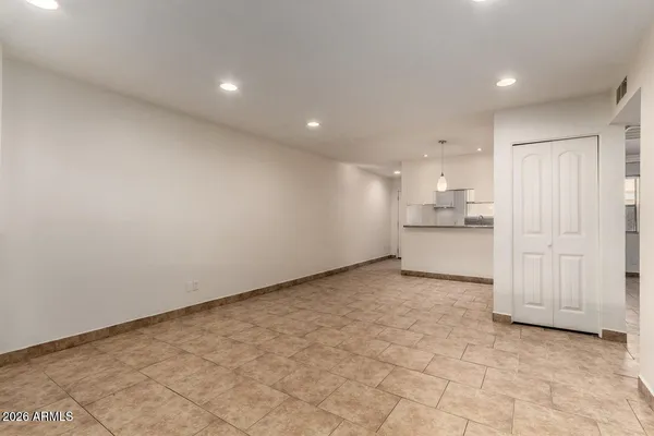 a view of a kitchen with a sink and dishwasher a refrigerator with white cabinets