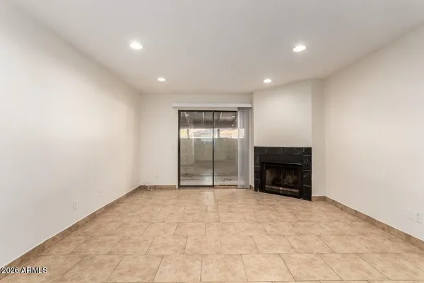 a view of an empty room with a fireplace
