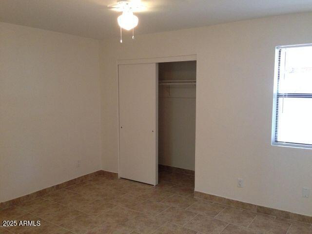 3119 North 38th Street, Unit 10 Phoenix, AZ 85018 - Photo 20 of 20 an empty room with windows and closet