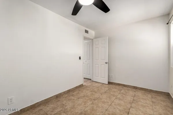 a view of empty room with ceiling fan