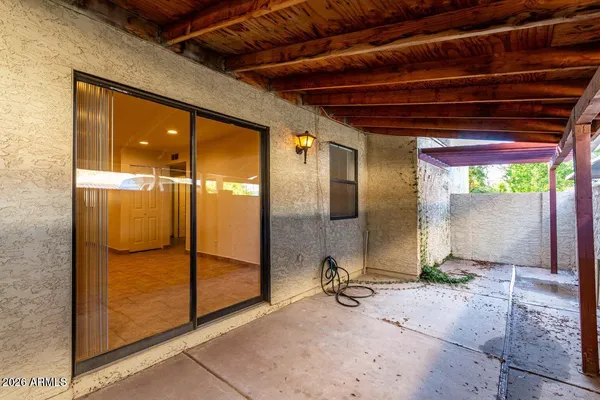 a view of a room with wooden floor and windows