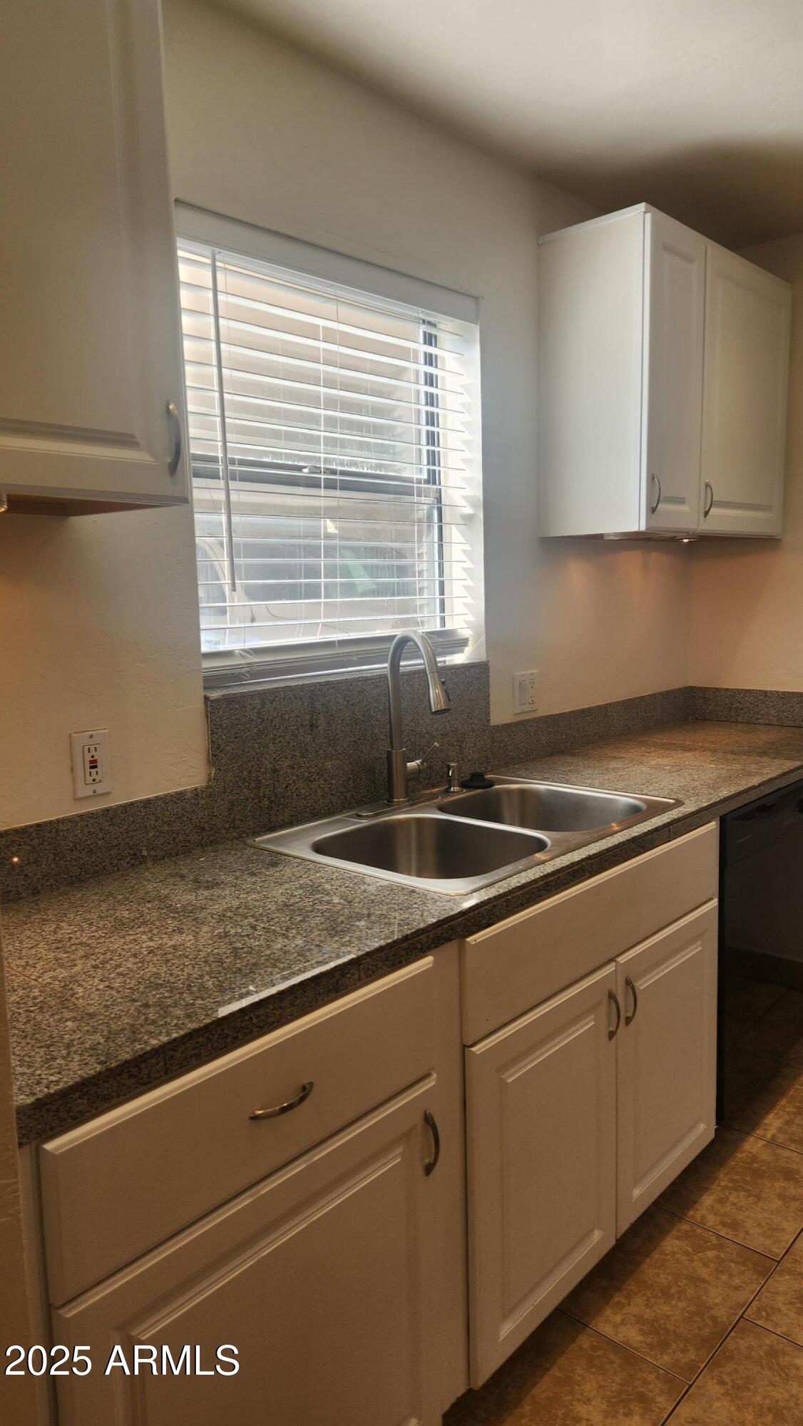 3119 North 38th Street, Unit 10 Phoenix, AZ 85018 - Photo 6 of 20 a kitchen with granite countertop a sink and white cabinets