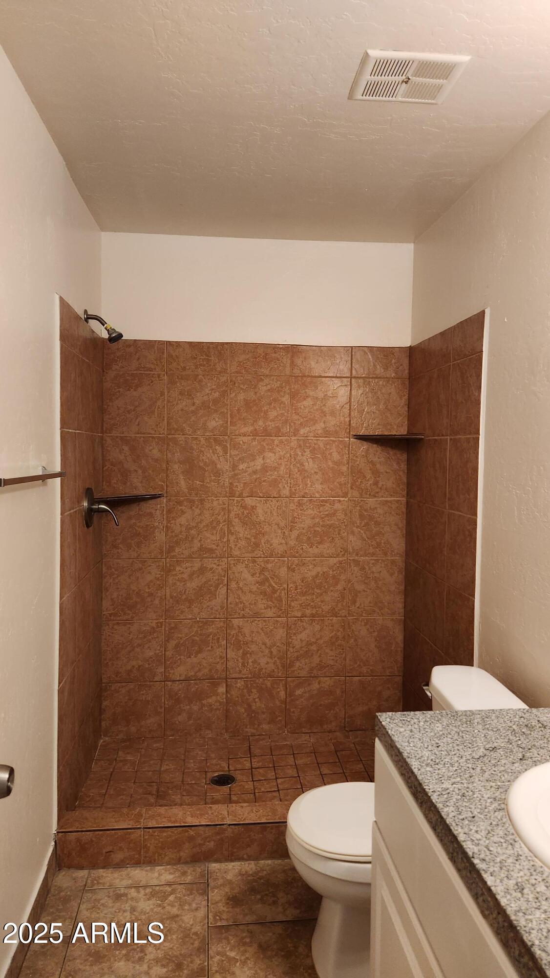 3119 North 38th Street, Unit 10 Phoenix, AZ 85018 - Photo 9 of 20 a bathroom with a granite countertop toilet and a sink