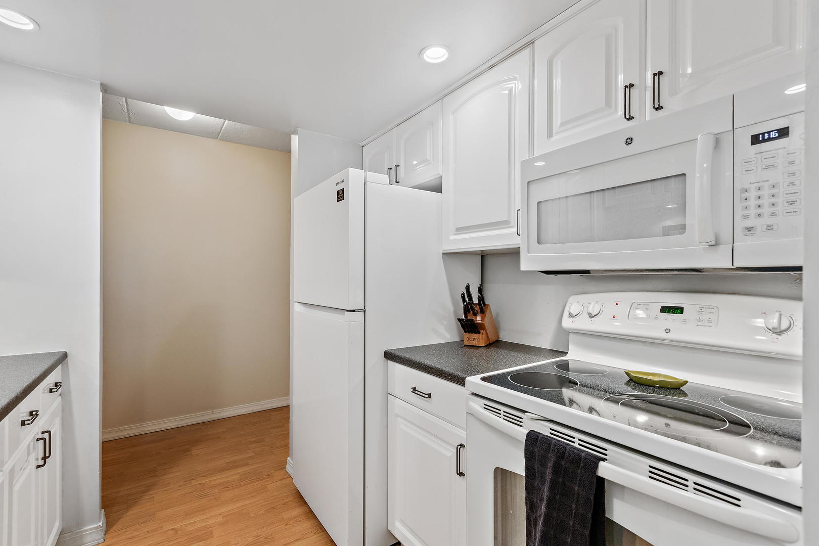 1 Renaissance Place, Unit 203 Palatine, IL 60067 - Photo 8 of 19 a kitchen with stainless steel appliances a refrigerator sink and cabinets