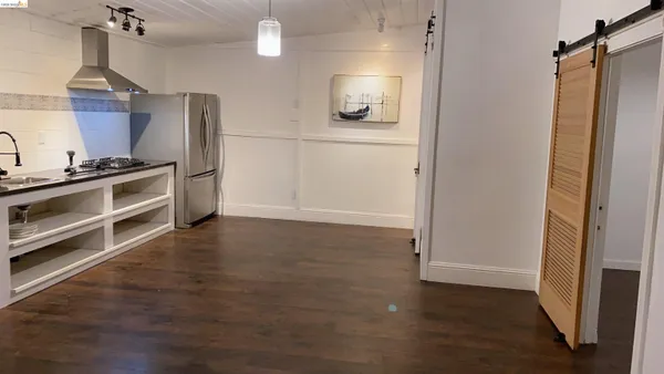 a kitchen with granite countertop a refrigerator and a stove