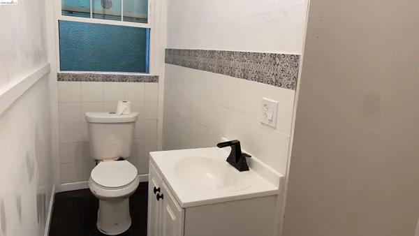 a bathroom with a toilet a sink and mirror