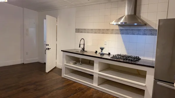 a stove top oven sitting inside of a kitchen