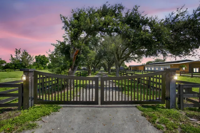 an aerial view of residential houses with outdoor space and lake view