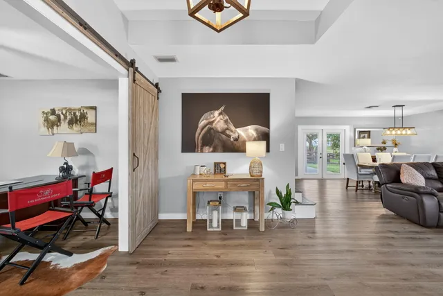 a kitchen with stainless steel appliances a refrigerator sink and wooden floor