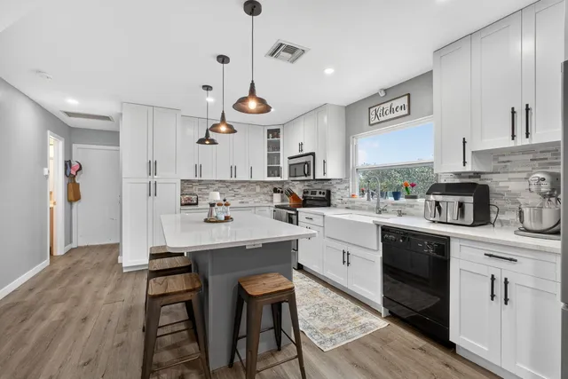 a view of a porch with a table and chairs and potted plants