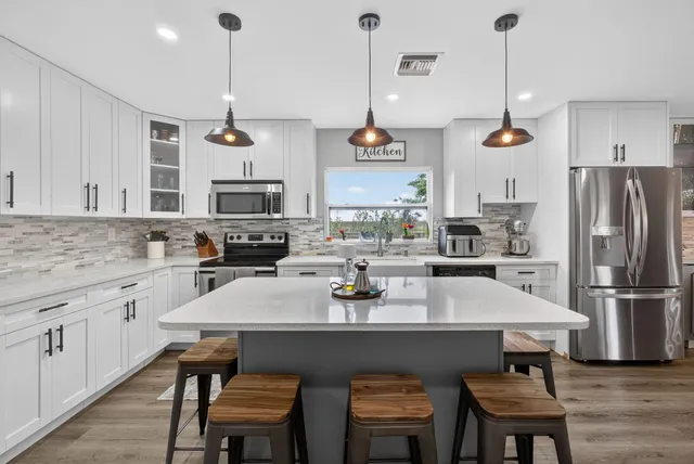 a view of swimming pool with a yard and large tree