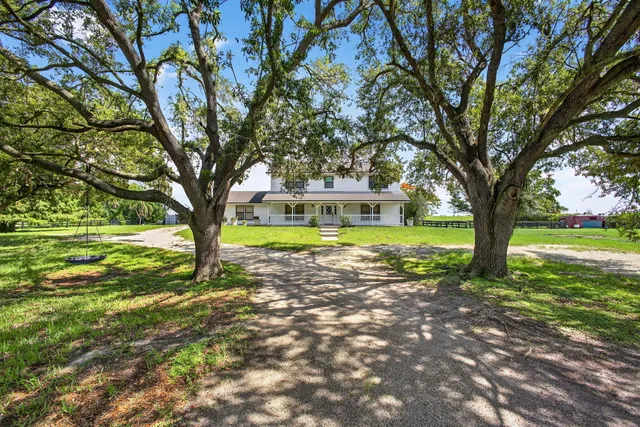 a living room with furniture flat screen tv and a large window