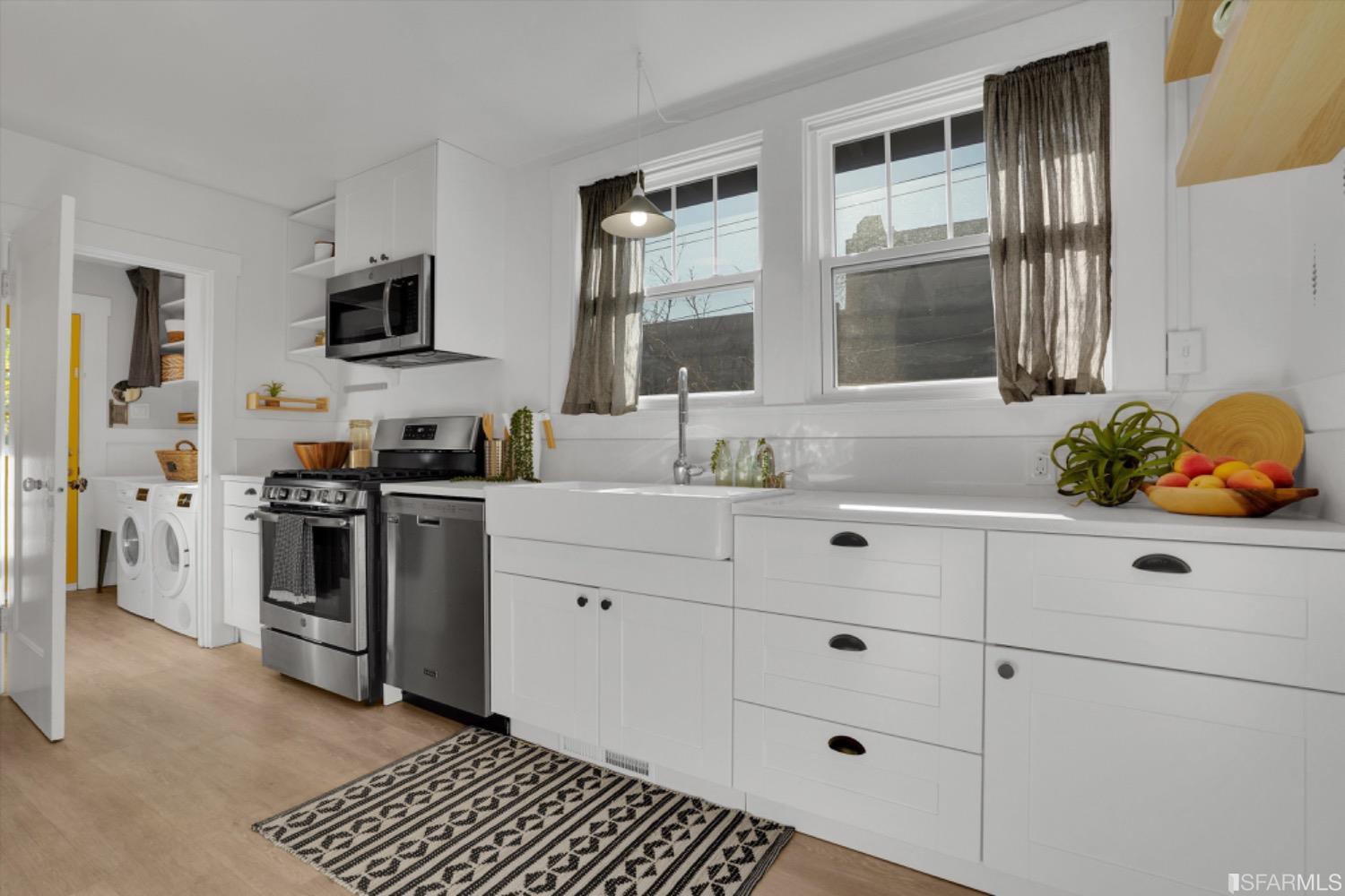 1921 Seventh Street Berkeley, CA 94710 - Photo 13 of 37 a kitchen with stainless steel appliances white cabinets and a window
