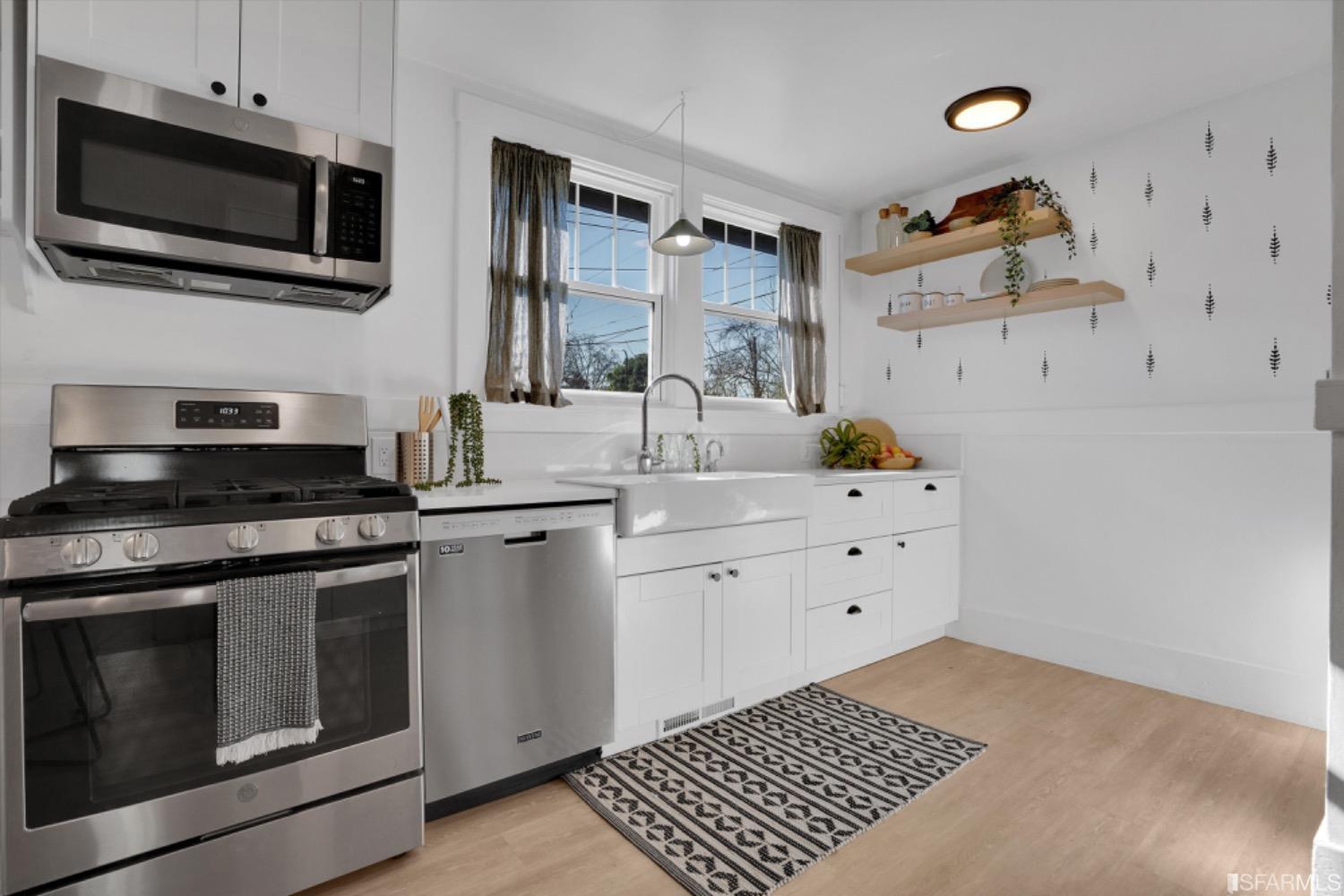 1921 Seventh Street Berkeley, CA 94710 - Photo 14 of 37 a kitchen with a sink stove and microwave