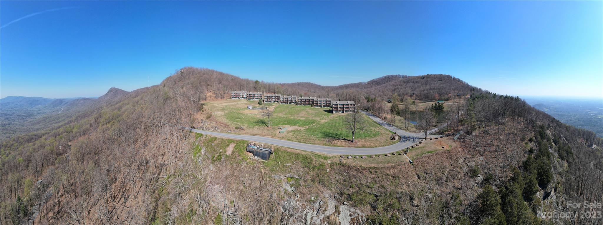 2881 White Oak Mountain Road, Unit D2 Columbus, NC 28722 - Photo 1 of 39 a view of a small house with a mountain in the background