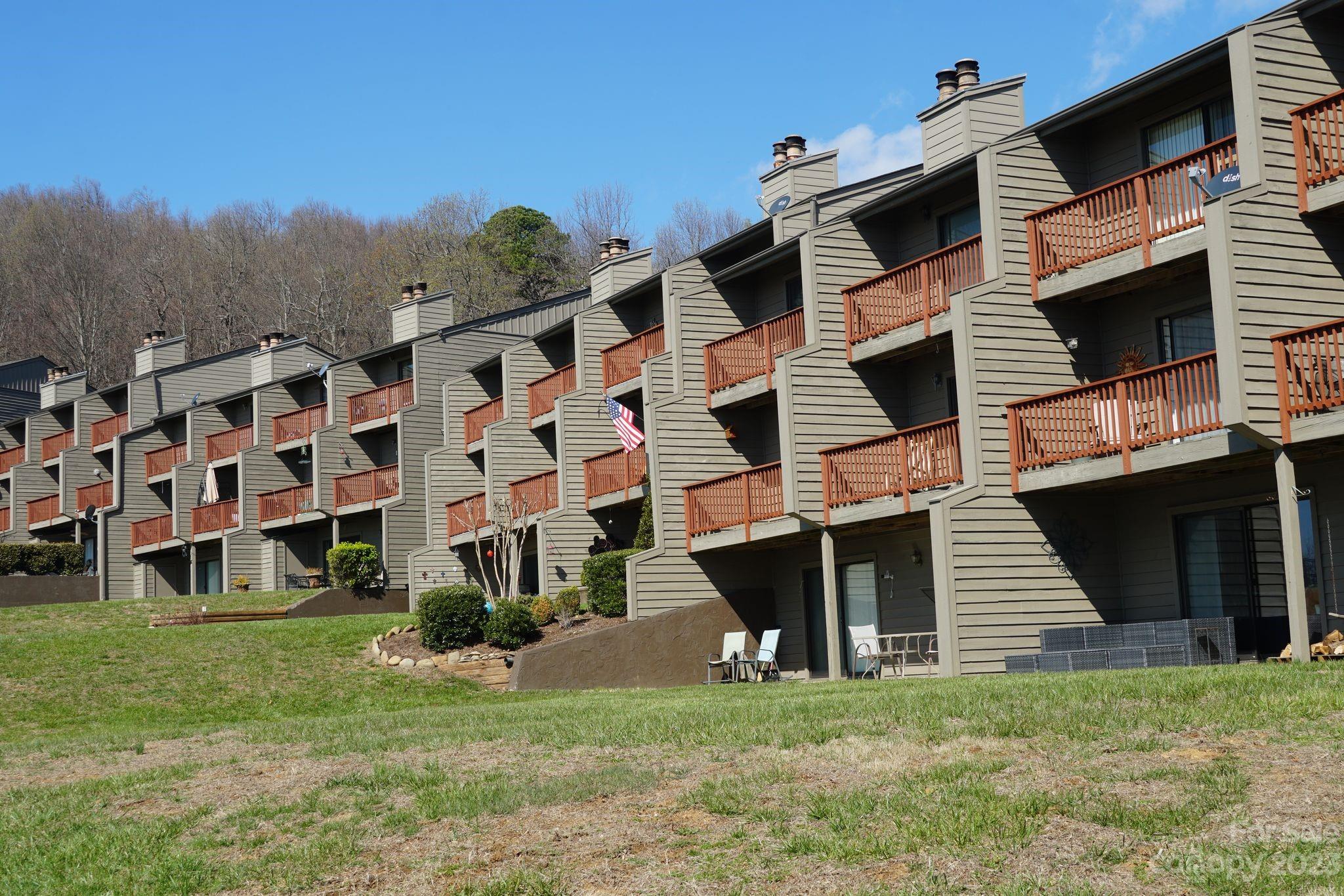 2881 White Oak Mountain Road, Unit D2 Columbus, NC 28722 - Photo 18 of 39 a view of a house with a yard