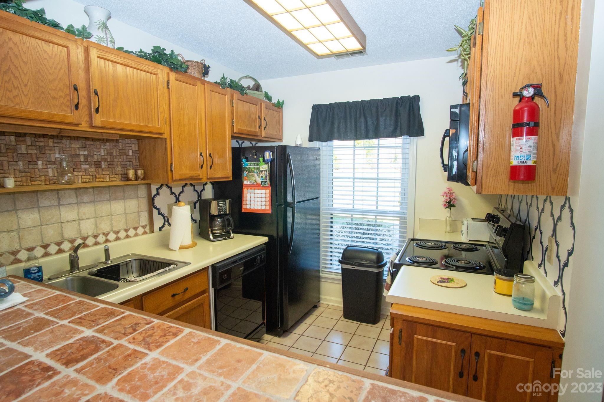 2881 White Oak Mountain Road, Unit D2 Columbus, NC 28722 - Photo 21 of 39 a kitchen with stainless steel appliances a sink a stove and a refrigerator