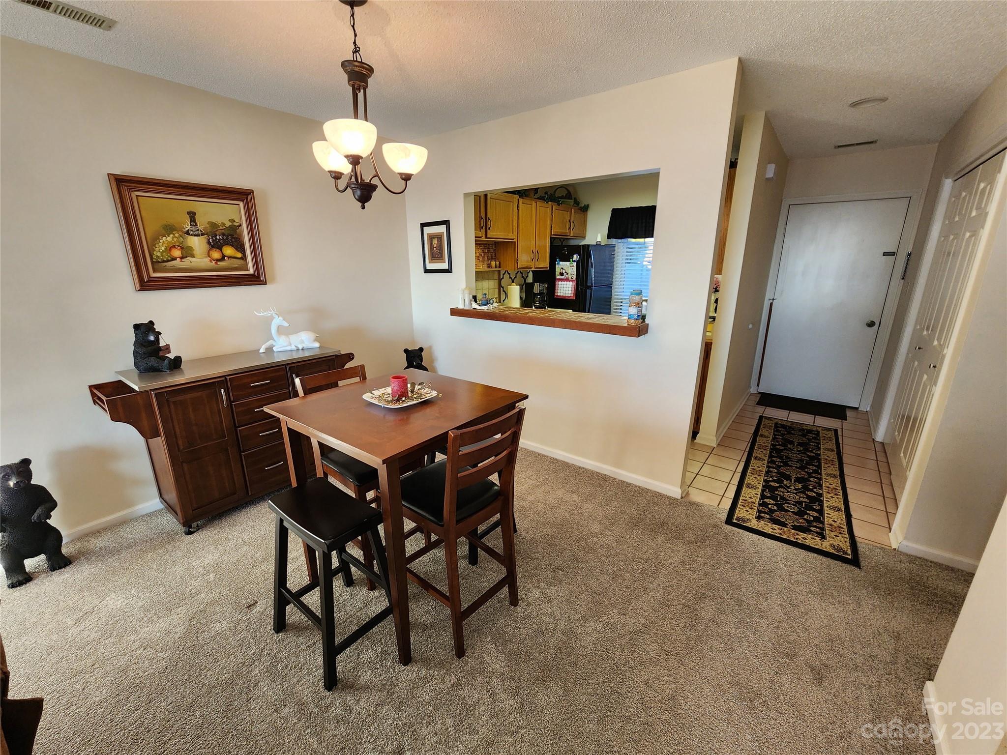 2881 White Oak Mountain Road, Unit D2 Columbus, NC 28722 - Photo 24 of 39 a view of a dining room with furniture and a chandelier