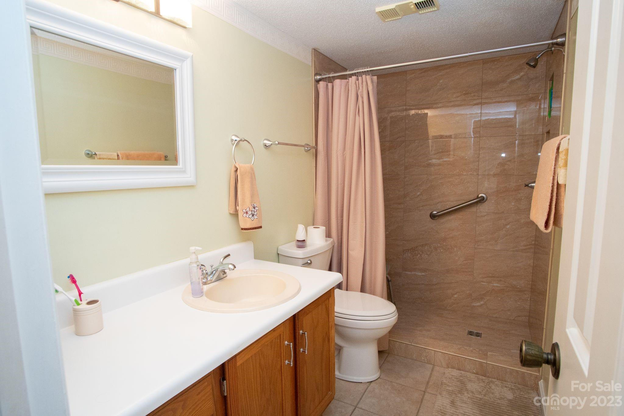 2881 White Oak Mountain Road, Unit D2 Columbus, NC 28722 - Photo 34 of 39 a bathroom with a sink toilet and shower