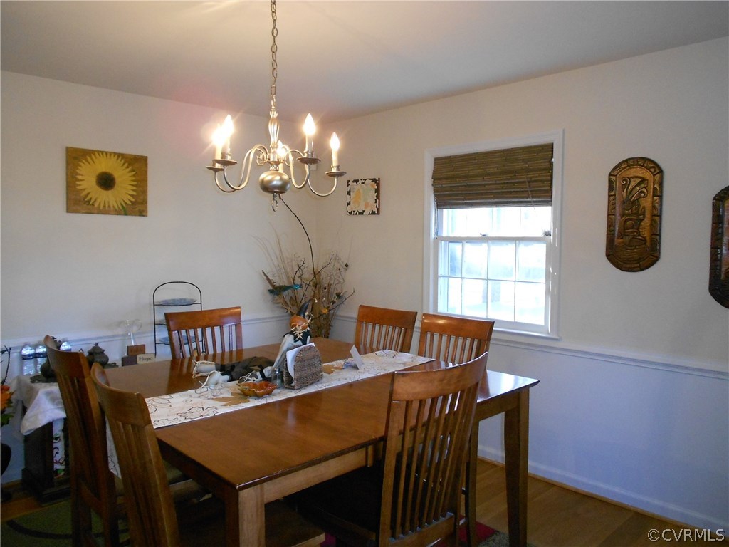11019 Rockledge Road Richmond, VA 23235 - Photo 15 of 36 a view of a dining room with furniture and chandelier