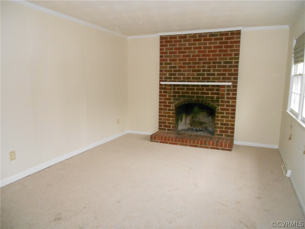 11019 Rockledge Road Richmond, VA 23235 - Photo 16 of 36 an empty room with a fireplace