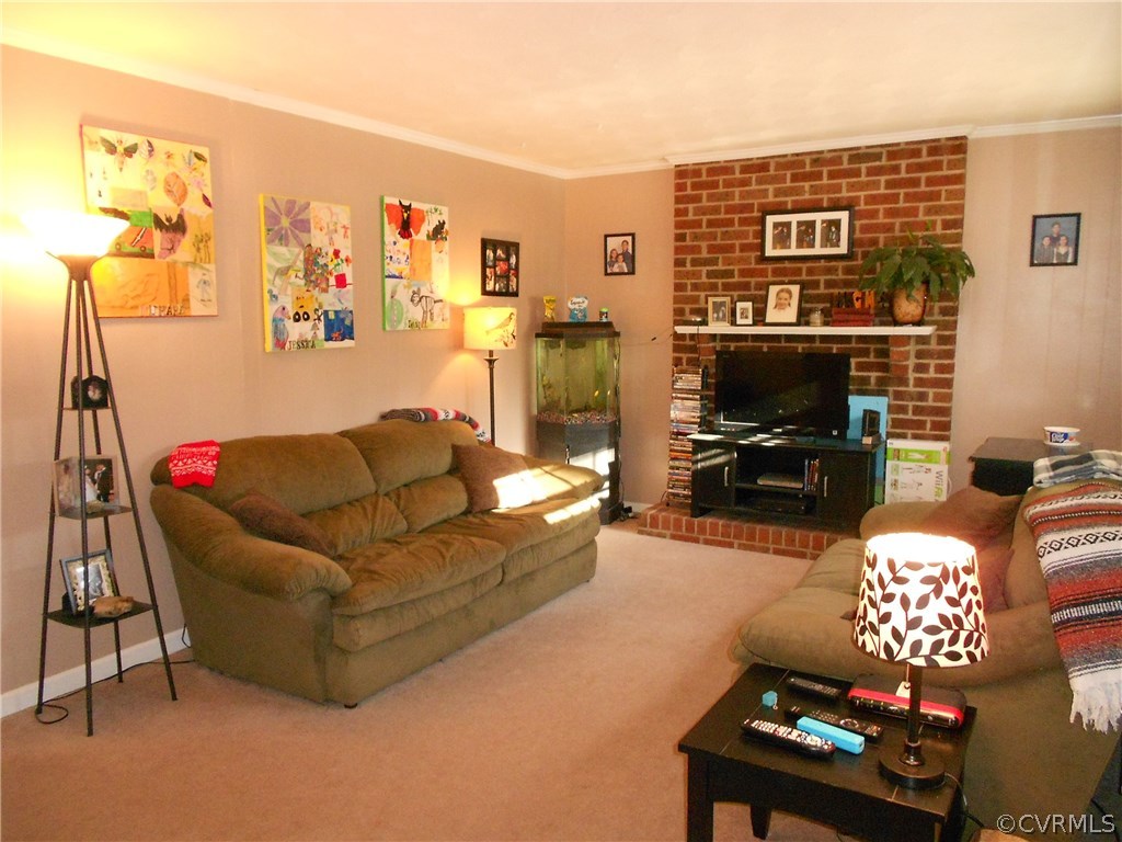 11019 Rockledge Road Richmond, VA 23235 - Photo 17 of 36 a living room with furniture cabinets and a flat screen tv