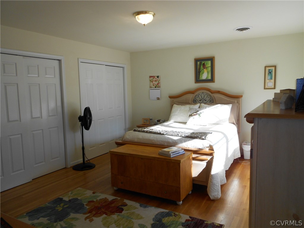 11019 Rockledge Road Richmond, VA 23235 - Photo 23 of 36 a bedroom with a bed and wooden floor