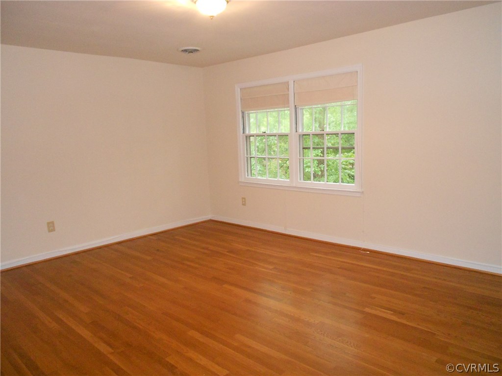 11019 Rockledge Road Richmond, VA 23235 - Photo 24 of 36 an empty room with wooden floor and a window