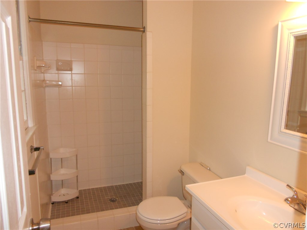 11019 Rockledge Road Richmond, VA 23235 - Photo 26 of 36 a white toilet sitting next to a bath tub and a shower
