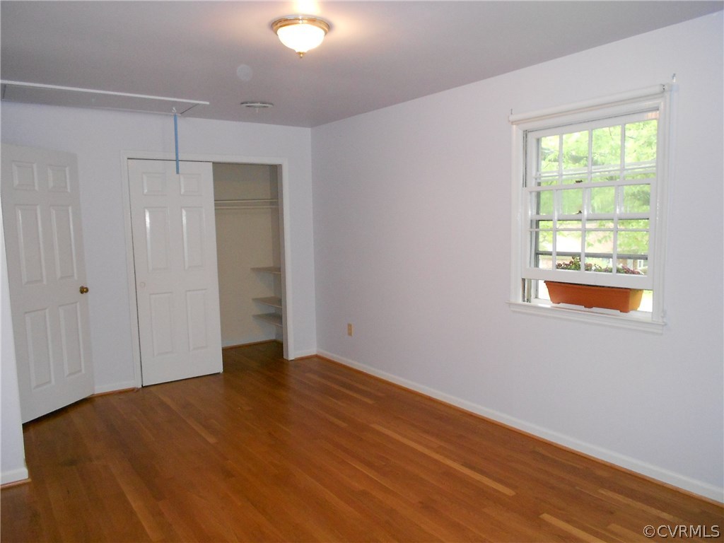 11019 Rockledge Road Richmond, VA 23235 - Photo 28 of 36 a view of an empty room with wooden floor and a window